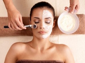 a woman receiving facial treatment