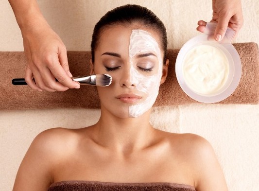 a woman receiving facial treatment